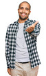 © Krakenimages.com - Hispanic adult man wearing casual clothes smiling friendly offering handshake as greeting and welcoming. successful business.