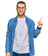 © Krakenimages.com - Young caucasian man wearing casual clothes with a big smile on face, pointing with hand finger to the side looking at the camera.