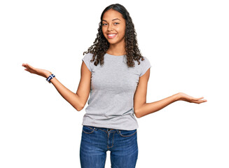 Canvas Print - Young african american girl wearing casual clothes smiling showing both hands open palms, presenting and advertising comparison and balance