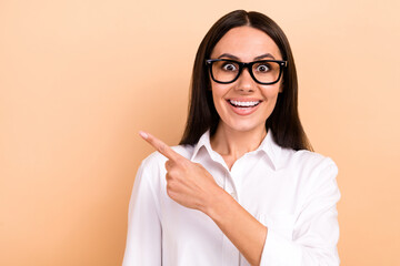 Sticker - Portrait of astonished pretty girl toothy smile direct finger empty space proposition isolated on beige color background