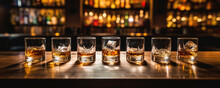 Whiskey Glasses In Row At Wooden Bar In Pup Or Restaurant.