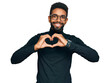 © Krakenimages.com - Young african american man wearing casual clothes smiling in love showing heart symbol and shape with hands. romantic concept.