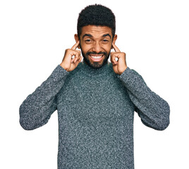 Poster - Young african american man wearing casual clothes covering ears with fingers with annoyed expression for the noise of loud music. deaf concept.