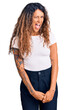 © Krakenimages.com - Young hispanic woman with tattoo wearing casual white tshirt winking looking at the camera with sexy expression, cheerful and happy face.