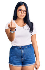 Wall Mural - Young beautiful asian girl wearing casual clothes and glasses showing middle finger, impolite and rude fuck off expression