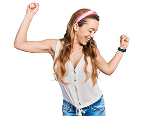 Canvas Print - Young caucasian woman wearing casual style with sleeveless shirt dancing happy and cheerful, smiling moving casual and confident listening to music