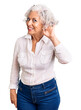 © Krakenimages.com - Senior grey-haired woman wearing casual clothes smiling with hand over ear listening an hearing to rumor or gossip. deafness concept.