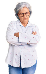 Sticker - Senior woman with gray hair wearing casual business clothes and glasses skeptic and nervous, disapproving expression on face with crossed arms. negative person.