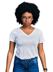 Poster - Young african american woman wearing casual white t shirt depressed and worry for distress, crying angry and afraid. sad expression.