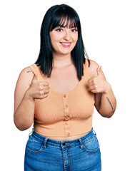 Sticker - Young hispanic plus size woman wearing casual clothes success sign doing positive gesture with hand, thumbs up smiling and happy. cheerful expression and winner gesture.