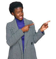 Sticker - Young african american girl wearing casual clothes pointing aside worried and nervous with both hands, concerned and surprised expression