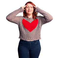 Sticker - Young beautiful redhead woman wearing casual heart sweater suffering from headache desperate and stressed because pain and migraine. hands on head.