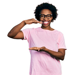 Sticker - African american woman with afro hair wearing casual clothes and glasses gesturing with hands showing big and large size sign, measure symbol. smiling looking at the camera. measuring concept.