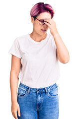 Canvas Print - Young beautiful woman with pink hair wearing casual clothes and glasses tired rubbing nose and eyes feeling fatigue and headache. stress and frustration concept.