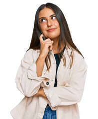 Wall Mural - Beautiful hispanic woman wearing casual clothes serious face thinking about question with hand on chin, thoughtful about confusing idea