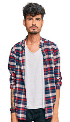 Poster - Young hispanic man wearing casual clothes depressed and worry for distress, crying angry and afraid. sad expression.