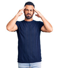 Young Hispanic Man Wearing Casual Clothes Suffering From Headache Desperate And Stressed Because Pain And Migraine. Hands On Head.