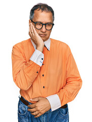 Wall Mural - Middle age indian man wearing casual clothes and glasses thinking looking tired and bored with depression problems with crossed arms.