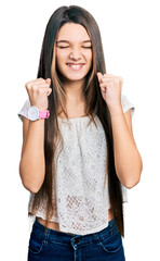 Poster - Young brunette girl with long hair wearing white shirt excited for success with arms raised and eyes closed celebrating victory smiling. winner concept.