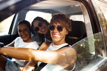 Women Sitting In Car And Smiling At Camera