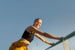 © ADDICTIVE STOCK - Young woman stretching after working out outdoors at sunset