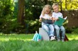 © BillionPhotos.com - Happy little children's reading books in park