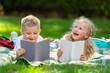 © BillionPhotos.com - Happy little children's reading books in park