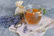 Fresh delicious tea with lavender and lavender flowers on gray stone table