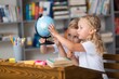 © BillionPhotos.com - Children with globe, interesting geography  learning.