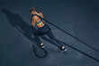 © USM Photography - Female athlete fitness rope pull training. Sporty sportswoman working out in functional training gym doing cross exercise with battle rope