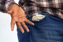 A Solemn Photograph Of A Man Displaying His Empty Pocket, Signifying His Financial Struggle And Lack Of Monetary Resources.