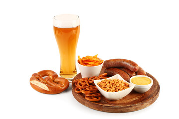 Glass of cold beer and plate with different snacks on white background. Oktoberfest celebration