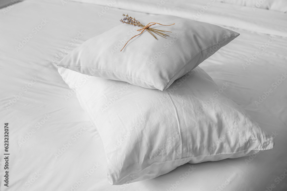 White pillows on bed in bedroom, closeup