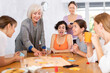© JackF - Women of different ages in casual clothes playing board games at table in office