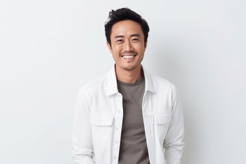 Portrait of a smiling asian man in white shirt on white background