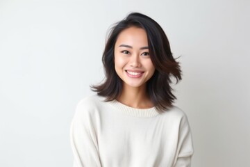 portrait of a beautiful young asian woman smiling on white background
