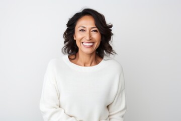 Wall Mural - Portrait of a happy mature woman smiling at camera over white background