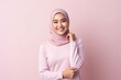 © Leon Waltz - Hijab woman with pink sweater and smile on pink background.