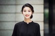 © Hanne Bauer - portrait of a young asian woman in black dress standing outdoors