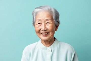 Medium shot portrait photography of a satisfied 100-year-old elderly chinese woman wearing a simple tunic against a pastel or soft colors background 