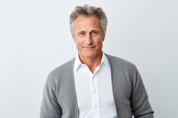 Lifestyle portrait photography of a pleased Russian man in his 50s wearing a chic cardigan against a white background 