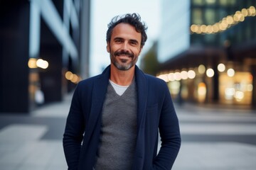 Wall Mural - Portrait of a handsome young man with a beard and mustache standing in the city