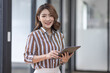 © David - Business, finance and employment, female successful entrepreneurs concept. Confident smiling asian businesswoman, office worker in office holding tablet, help clients