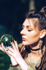 Portrait of a girl who holds a fortune-telling ball in her hands