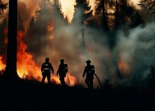 Silhouette Of A Firefighter As The Forest Is Burning And Full Of Smoke