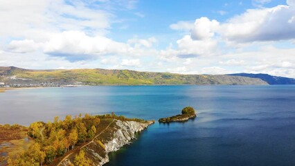 Wall Mural - Aerial view of Lake Baikal on a sunny autumn day. Shaman Cape. In the distance, the village of Kultuk.