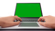 © FullFrames - 3d hand typing on laptop with green screen monitor display.