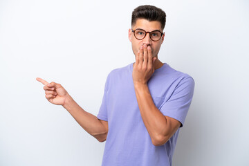 Wall Mural - Young caucasian man isolated on white background with surprise expression while pointing side