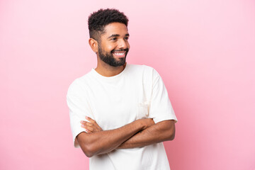 Wall Mural - Young Brazilian man isolated on pink background happy and smiling