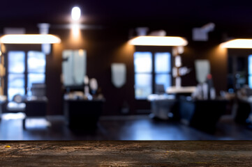 Wooden table with space for ads, background: blurry barber shop view.